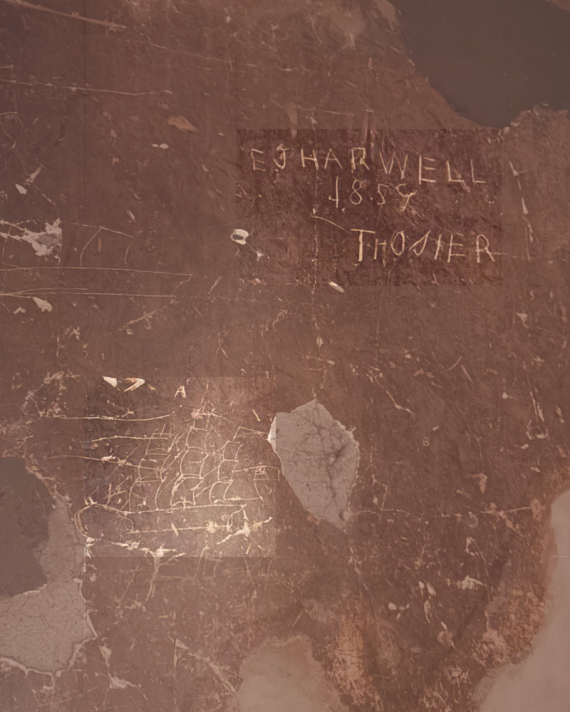 Child's drawing of a ship etched into a wall