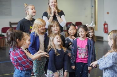 A group of children laughing and smiling.