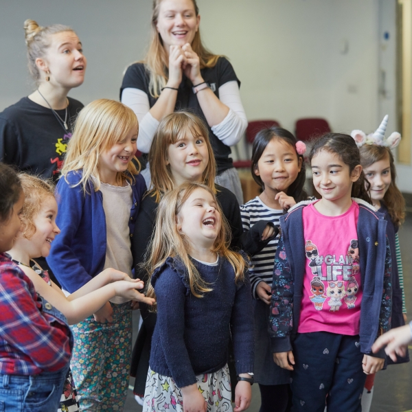 A group of children laughing and smiling.